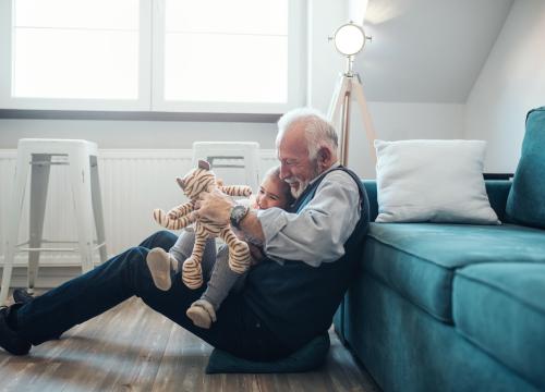 Older man playing with his granddaughter