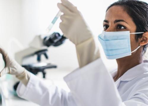 Researcher testing a vial in lab
