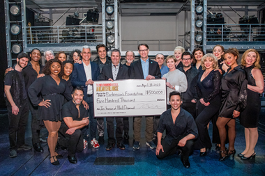 The cast of A Beautiful Noise, the Neil Diamond musical presents a $500,000 check to Parkinson's Foundation CEO