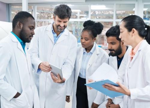 Group of researchers in the lab talking