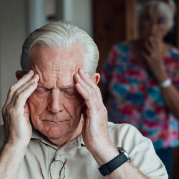 Man distressed with head in hands