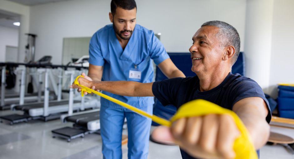 Man doing physical therapy exercises using a stretch band