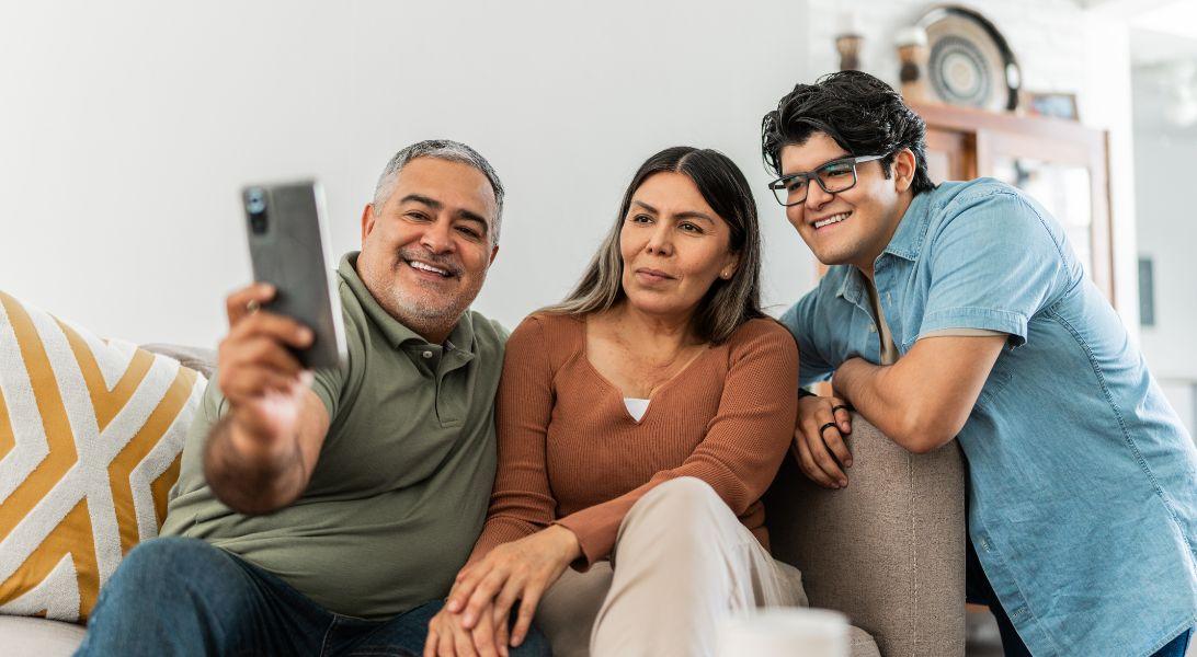 Family of three taking a selfie together