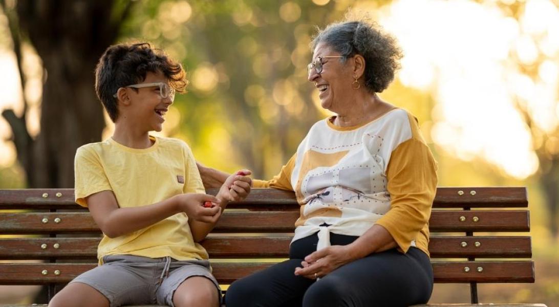 Grandma and grandson on park bench laughing