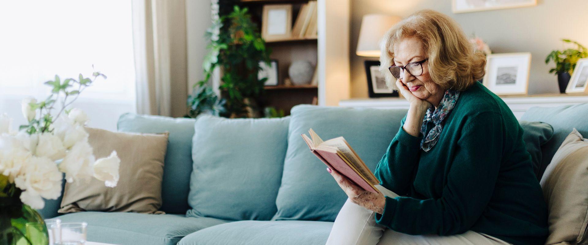 Woman reading a book on the couch