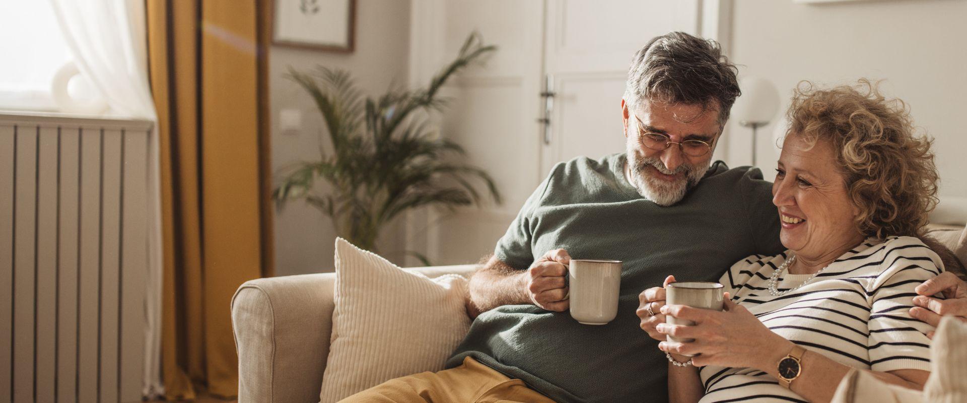 Couple drinking coffee on couch