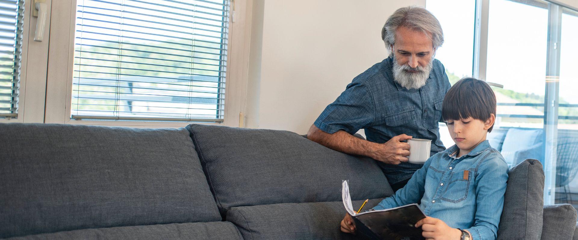 Grandfather helping grandson with homework