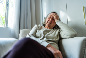 Women sitting on couch in pain