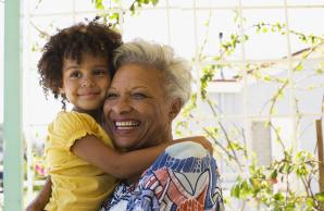 Grandmother holding granddaughter smiling