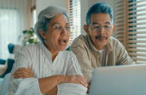 Asian couple engaging on laptop video call