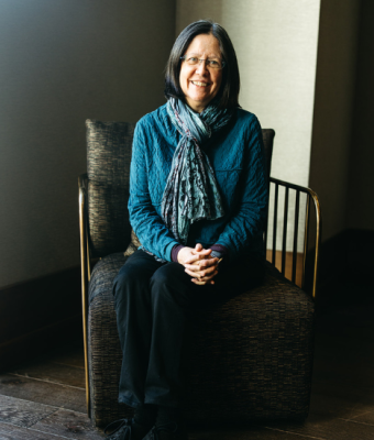 Kathy Blake sitting on a chair posing for a picture