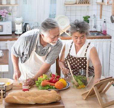 Husband and wife cooking together