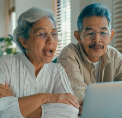 Asian couple engaging on laptop video call