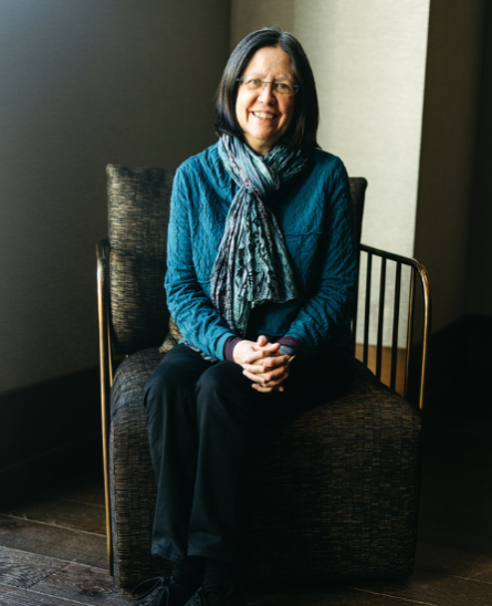 Kathy Blake sitting on a chair posing for a picture