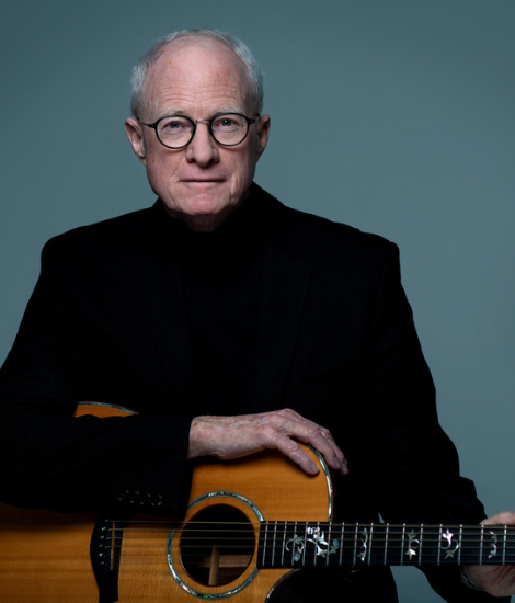 Bob Regan posing for a picture with a guitar