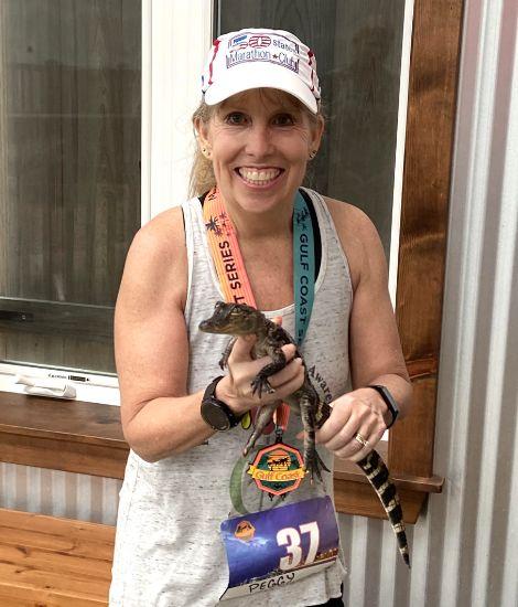 Peggy Faber holding a baby crocodile after a race