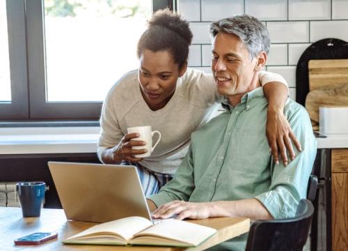 Couple looking at laptop at the kitchen table