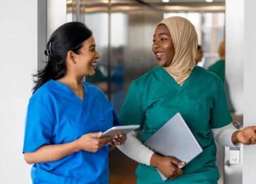 2 nurses having a conversation by elevator