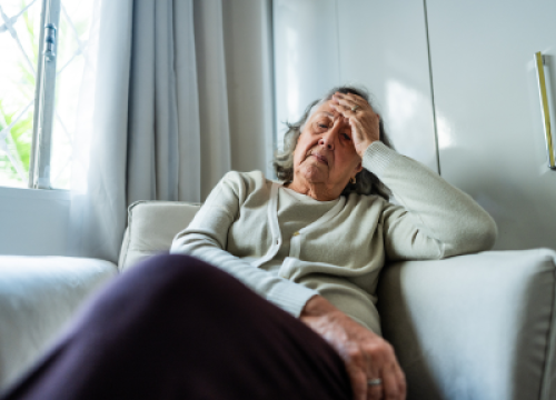 Women sitting on couch in pain