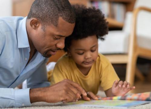 Father reading a book with daughter