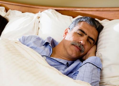 Husband and wife sleeping in bed