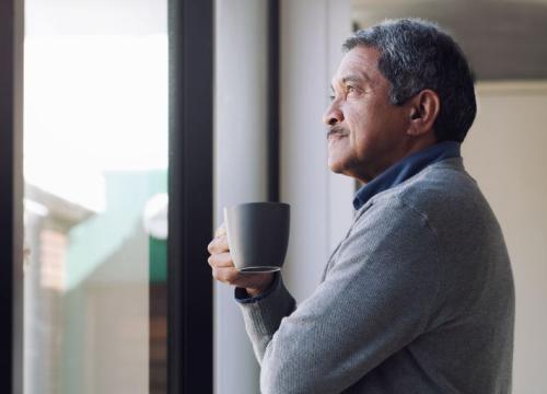 Man looking thoughtfully out the window