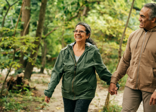 Man and woman having fun while walking in the woods