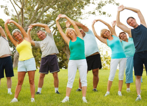 Group of people stretching outside