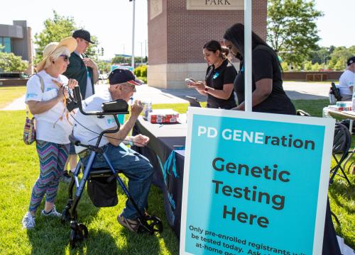 People visiting a booth for PD GENEration testing in Omaha