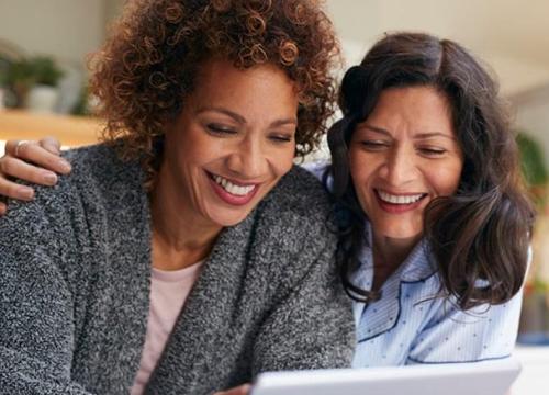 2 women looking at ipad