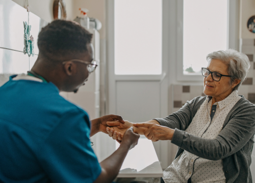 Nurse checking patient's hands