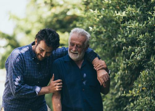 Father and son walking and hugging