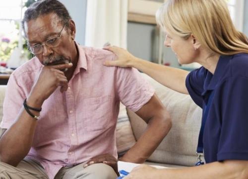 Man sitting on couch with counselor