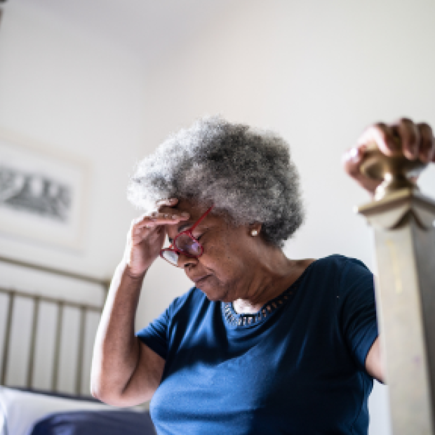 Older woman hunched over in pain