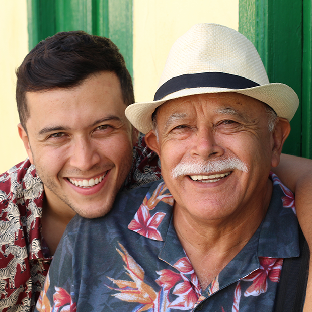 Father and son smiling at the camera