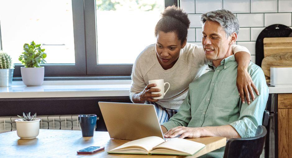 Couple looking at laptop at the kitchen table