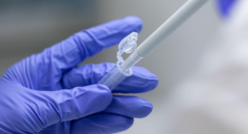 Researcher putting liquid in test tube