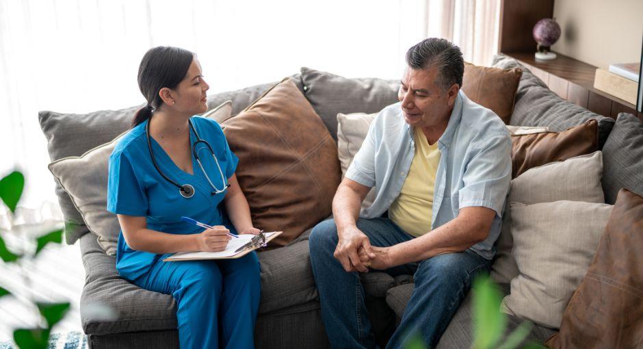 Nurse talking to a man during consultation