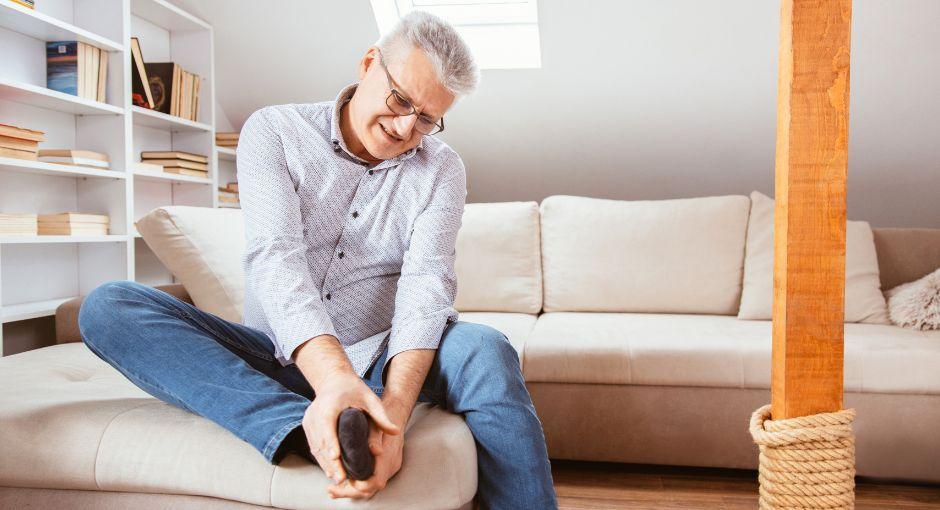 Man holding his foot in pain