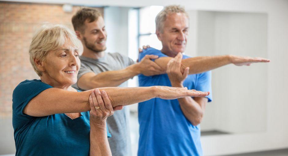 Senior people exercising with fitness trainer