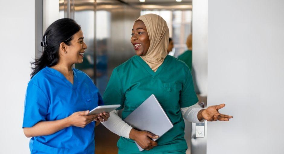 2 nurses having a conversation by elevator