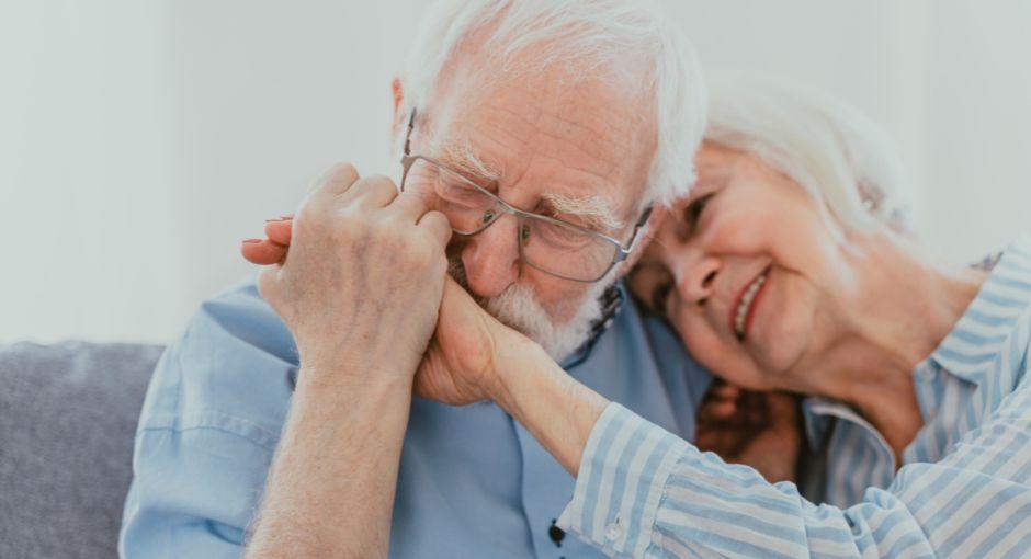 Man kissing his wife's hand