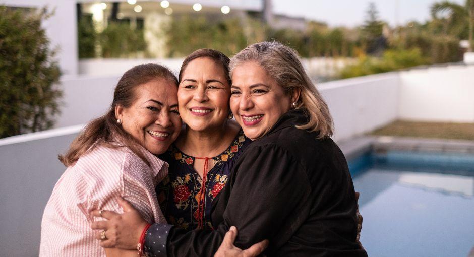 Three women hugging