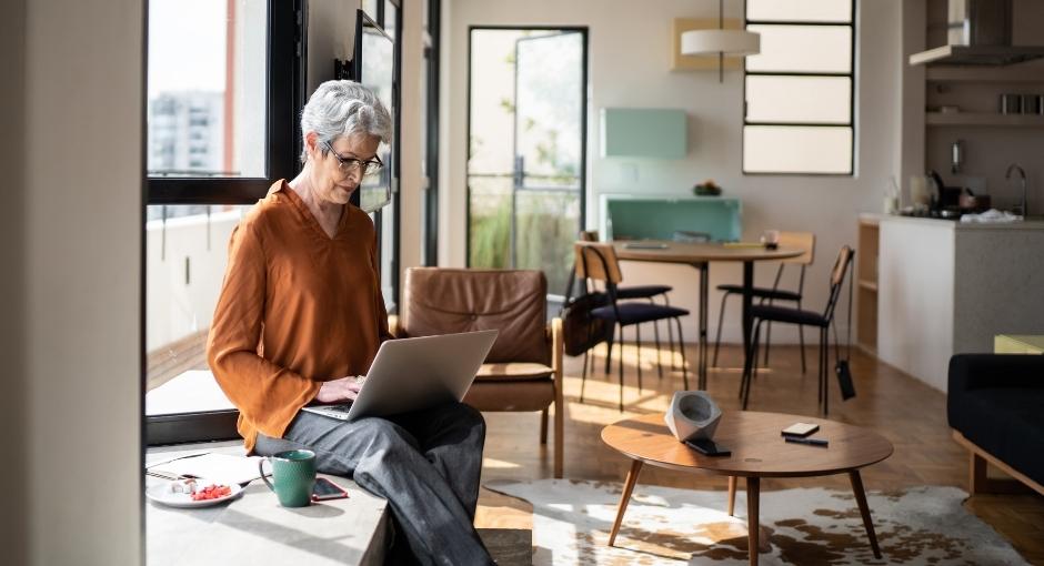 Woman sitting in her house on her laptop