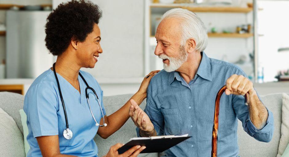 Nurse sitting with patient going over paperwork