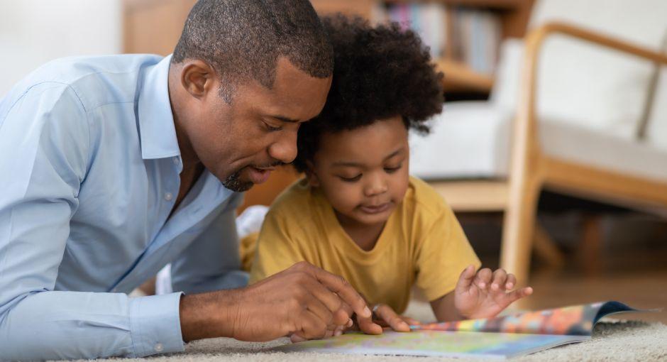 Father reading a book with daughter