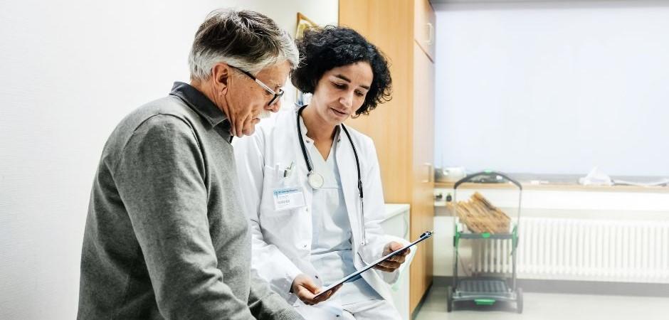 Nurse sitting with patient going over paperwork