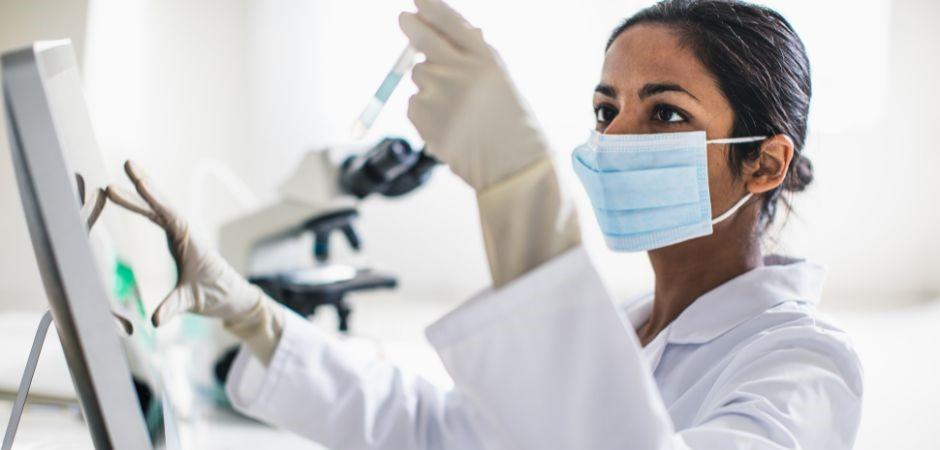 Researcher testing a vial in lab