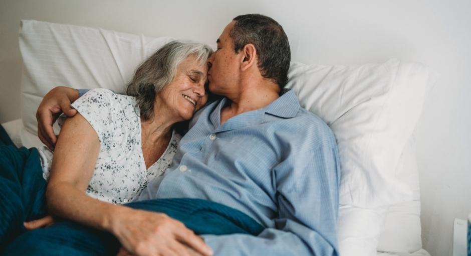 Couple cuddling in bed