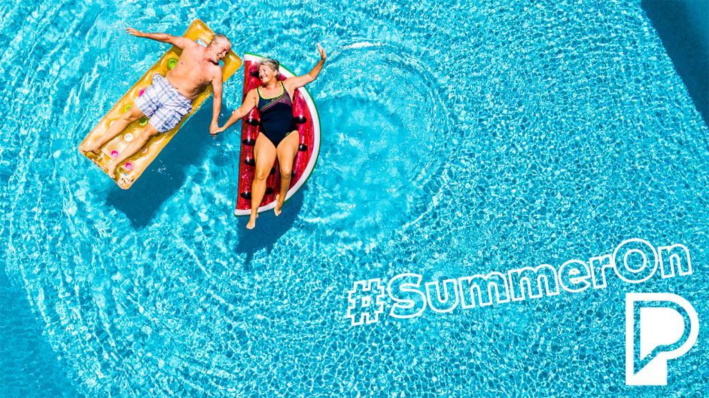 Older couple floating in a pool